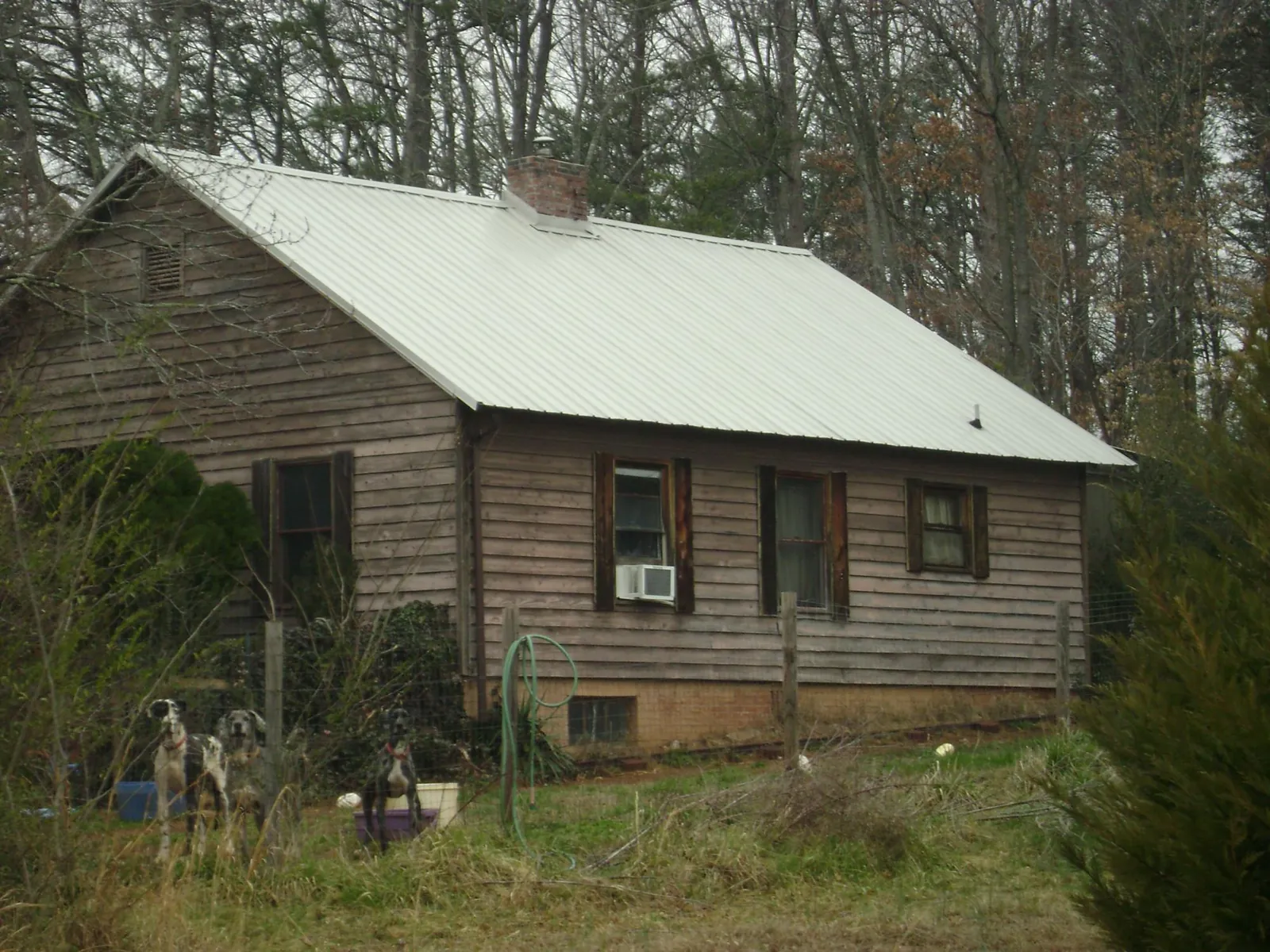 White metal roof on an old wood sided farmhouse, from a Metal Roof Installation job in Milmay
